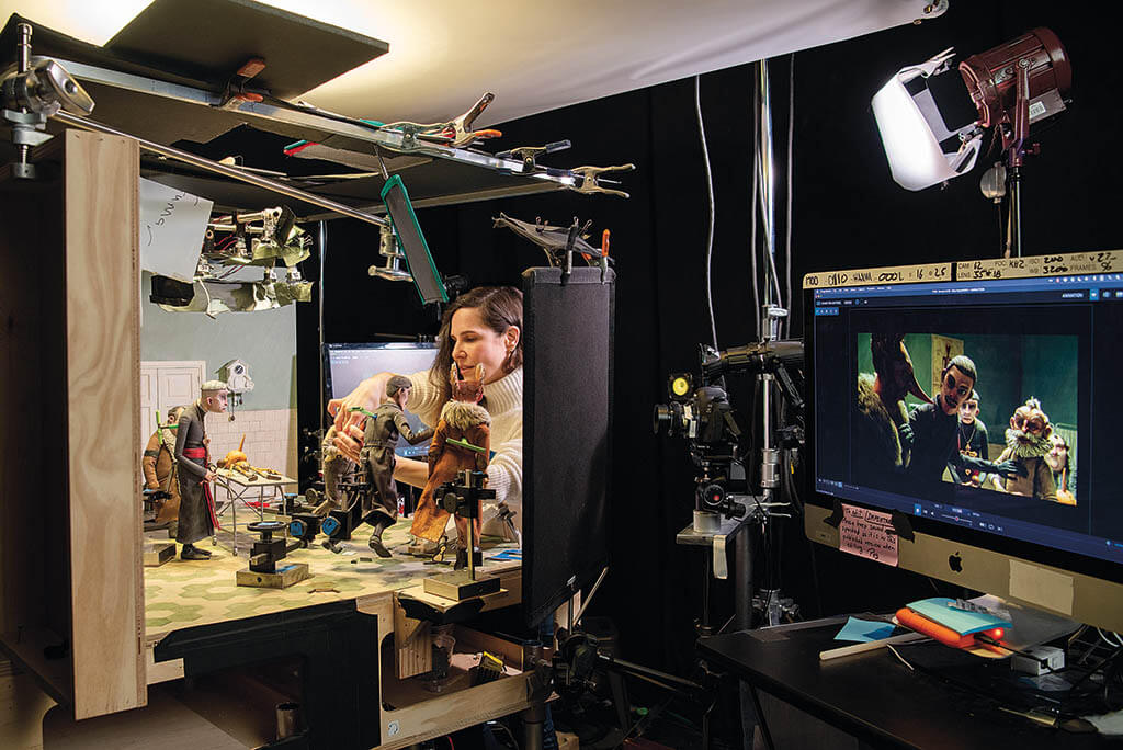 Animator Peggy Arel repositions the Geppetto puppet on the doctor’s office set.