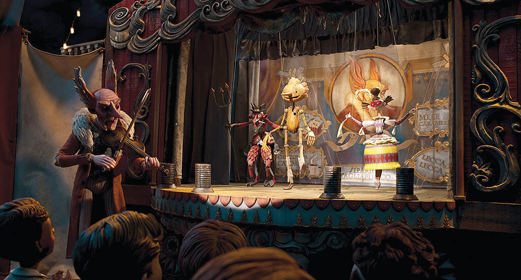 Pinocchio (voiced by Gregory Mann) becomes a performer at a carnival run by Volpe (voiced by Christoph Waltz), which plays upon the idea of Pinocchio being an actual puppet.