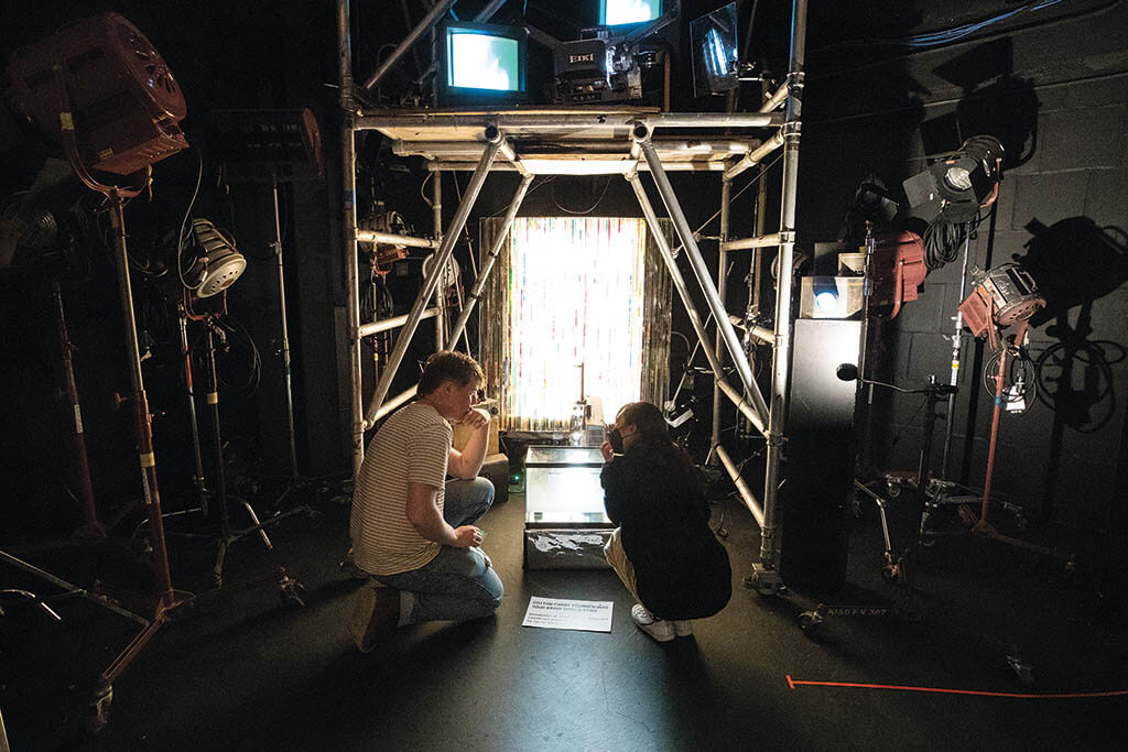 TOP TO BOTTOM: Student Carter Hiett and alumna and faculty member Judy Kim gather around Carter’s experimental film installation in the Film/Animation/ Design department at the Rhode Island School of Design. (Image courtesy of Jo Sittenfeld and RISD).