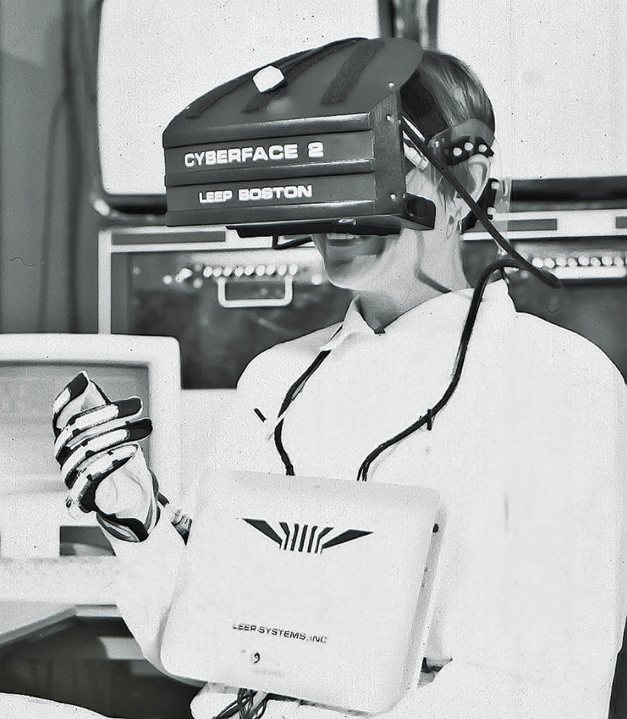 Morie in the Leep System’s Cyberface 2 head-mounted display, wearing the VSL’s own data glove, designed by Daniel P. Mapes, in 1991.