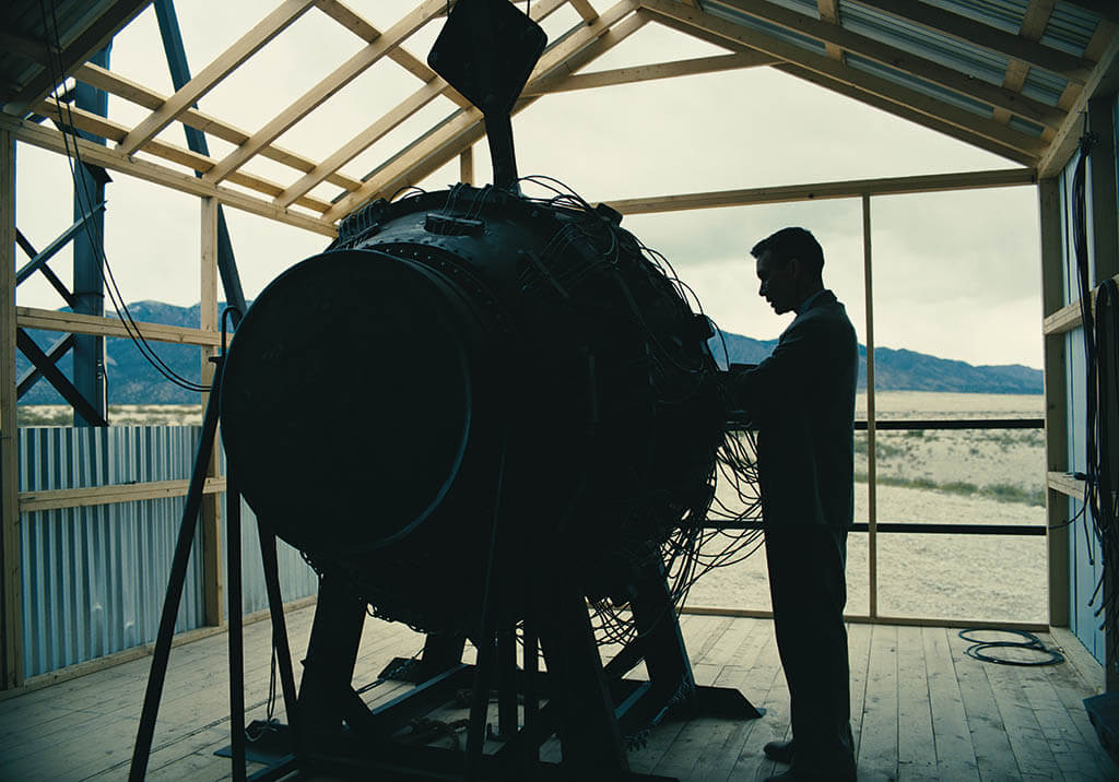 Robert Oppenheimer (Cillian Murphy) examines the atomic bomb prior to the weapon’s first test