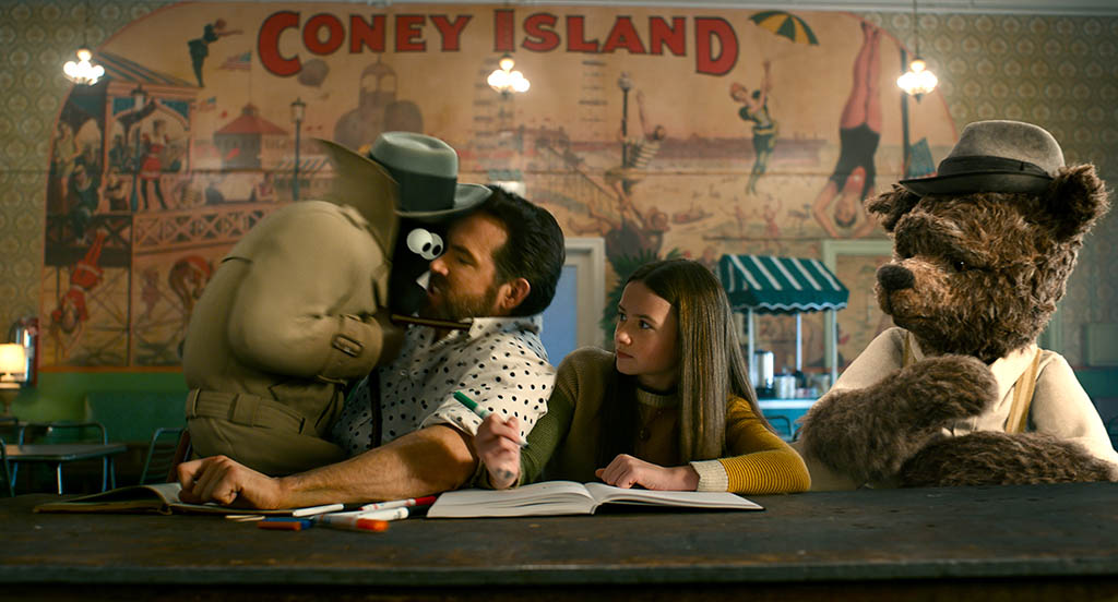 Cosmo (Christopher Meloni) gets in Ryan Reynolds' face, although it was director Krasinski who initially “attacked” Reynolds to get him in that position for the animation. Cailey Fleming (Bea) and Louis Gossett Jr. (Lewis) share the moment.