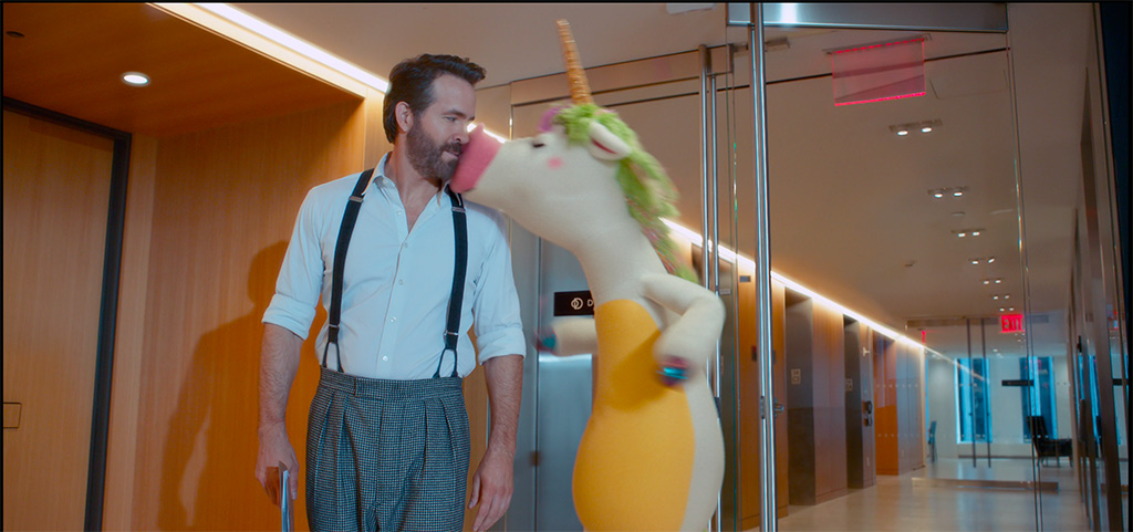 Director John Krasinski ready on set with the Unicorn model for positioning purposes with Ryan Reynolds, to be replaced by the animated character. Krasinski served as director, writer, producer and had a starring role in the film.