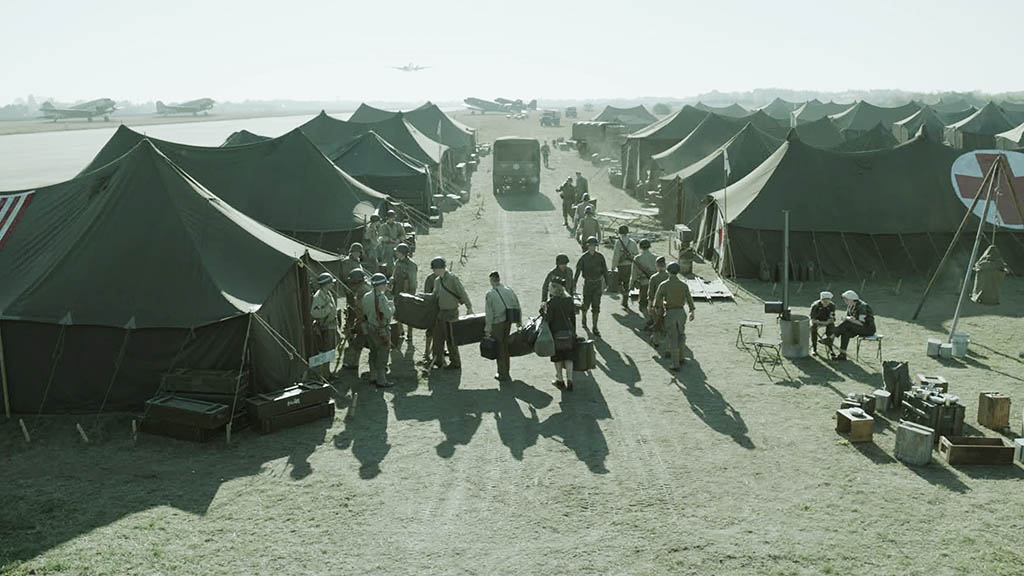 CG planes were added into the background for the airfield sequence, along with a sea of army tents in the foreground. The VFX needed to capture both the tone and style of Lee Miller’s photos.