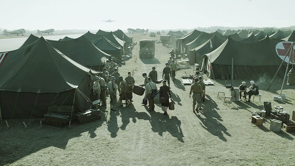 CG planes were added into the background for the airfield sequence, along with a sea of army tents in the foreground. The VFX needed to capture both the tone and style of Lee Miller’s photos.
