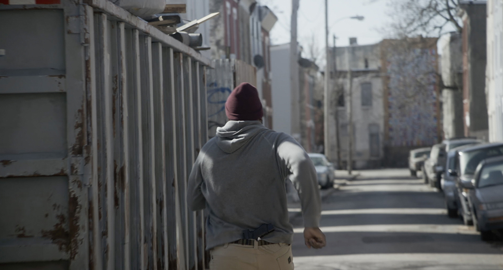 Ray Driscoll (Brian Tyree Henry) runs toward a CG truck.