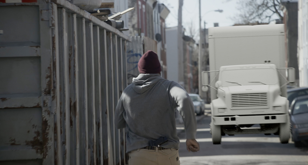 Ray Driscoll (Brian Tyree Henry) runs toward a CG truck.
