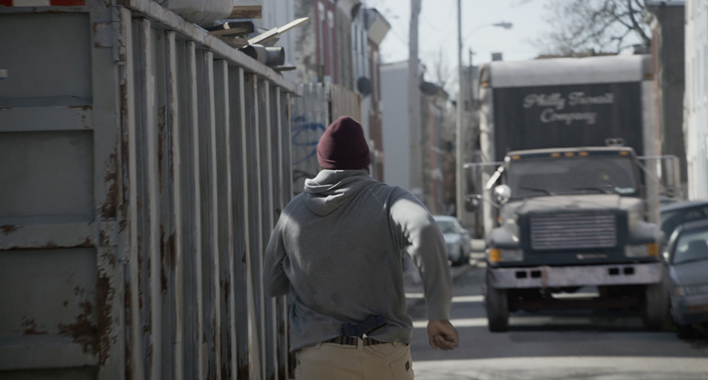Ray Driscoll (Brian Tyree Henry) runs toward a CG truck.
